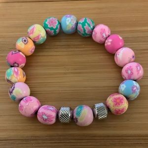Multicolor pink bead stretch bracelet with stainless steel accents. Brand new